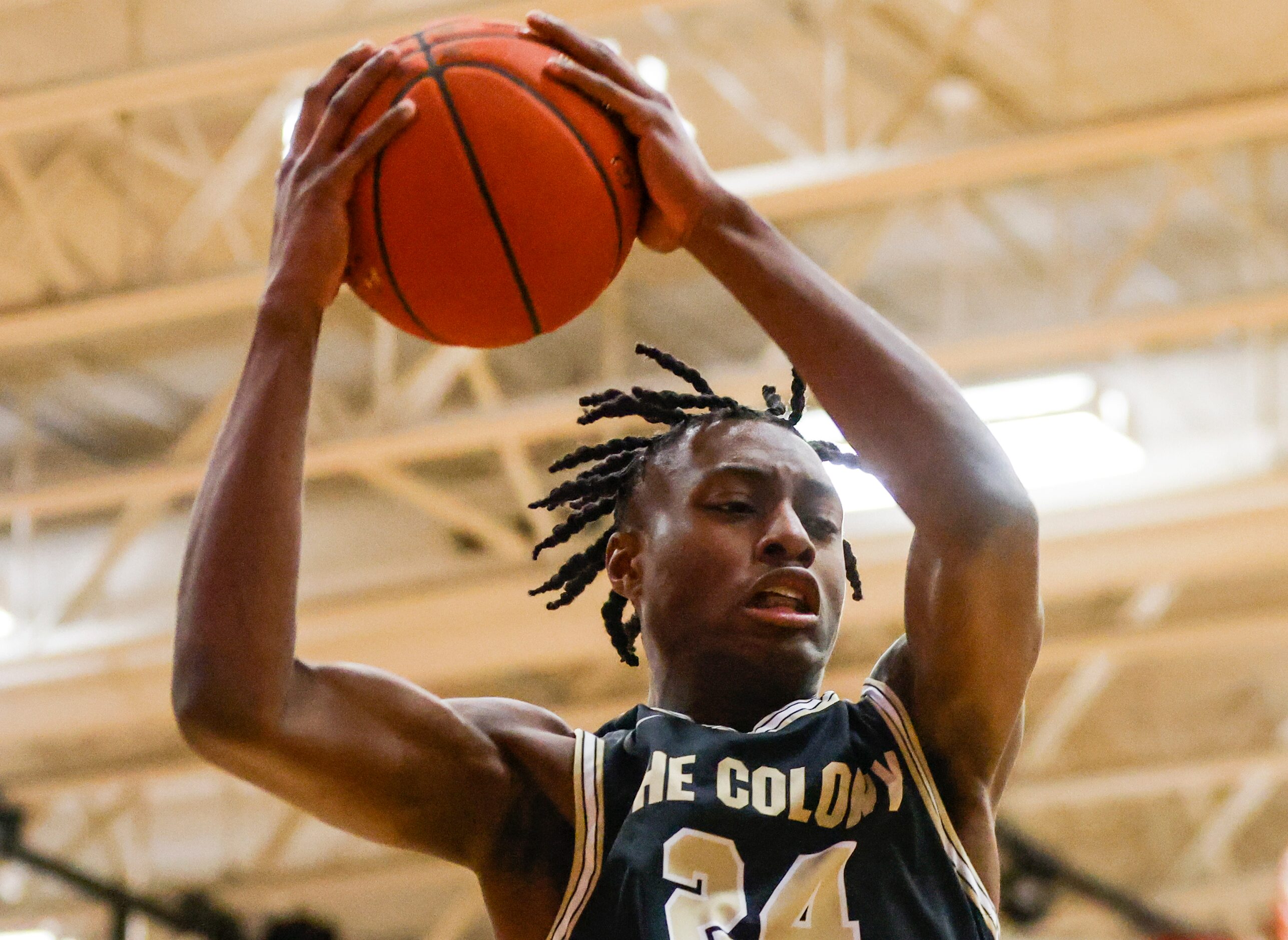 The Colony High School Xavier McKinney (24) jumps to catch a rebound shot at McKinney Boyd...