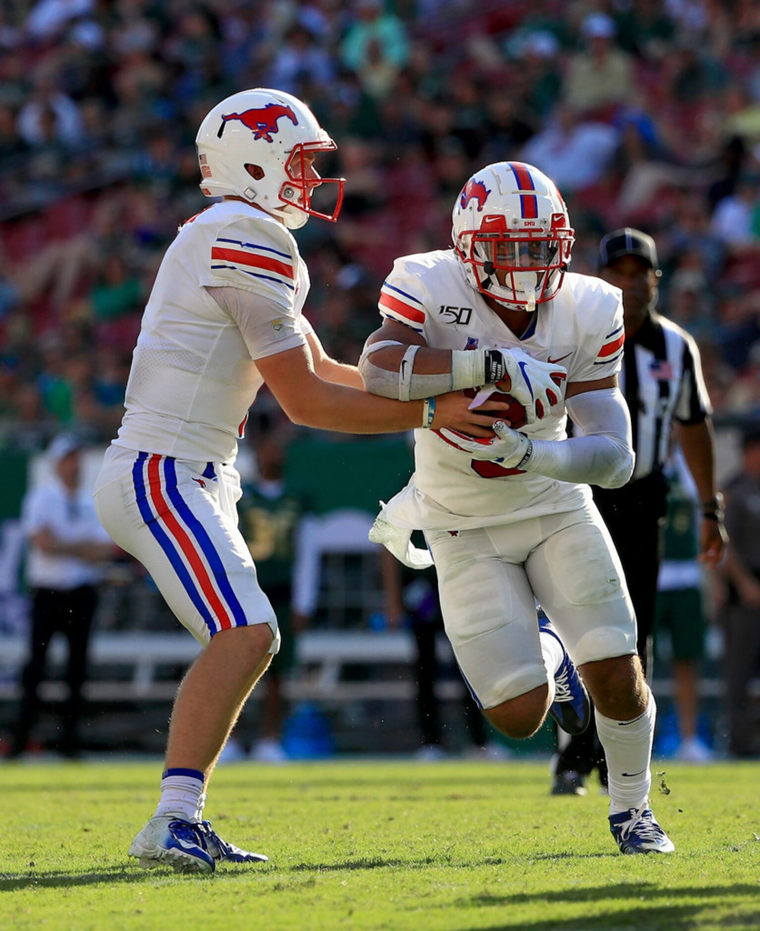 TAMPA, FLORIDA - SEPTEMBER 28: Shane Buechele #7 of the Southern Methodist Mustangs hands...