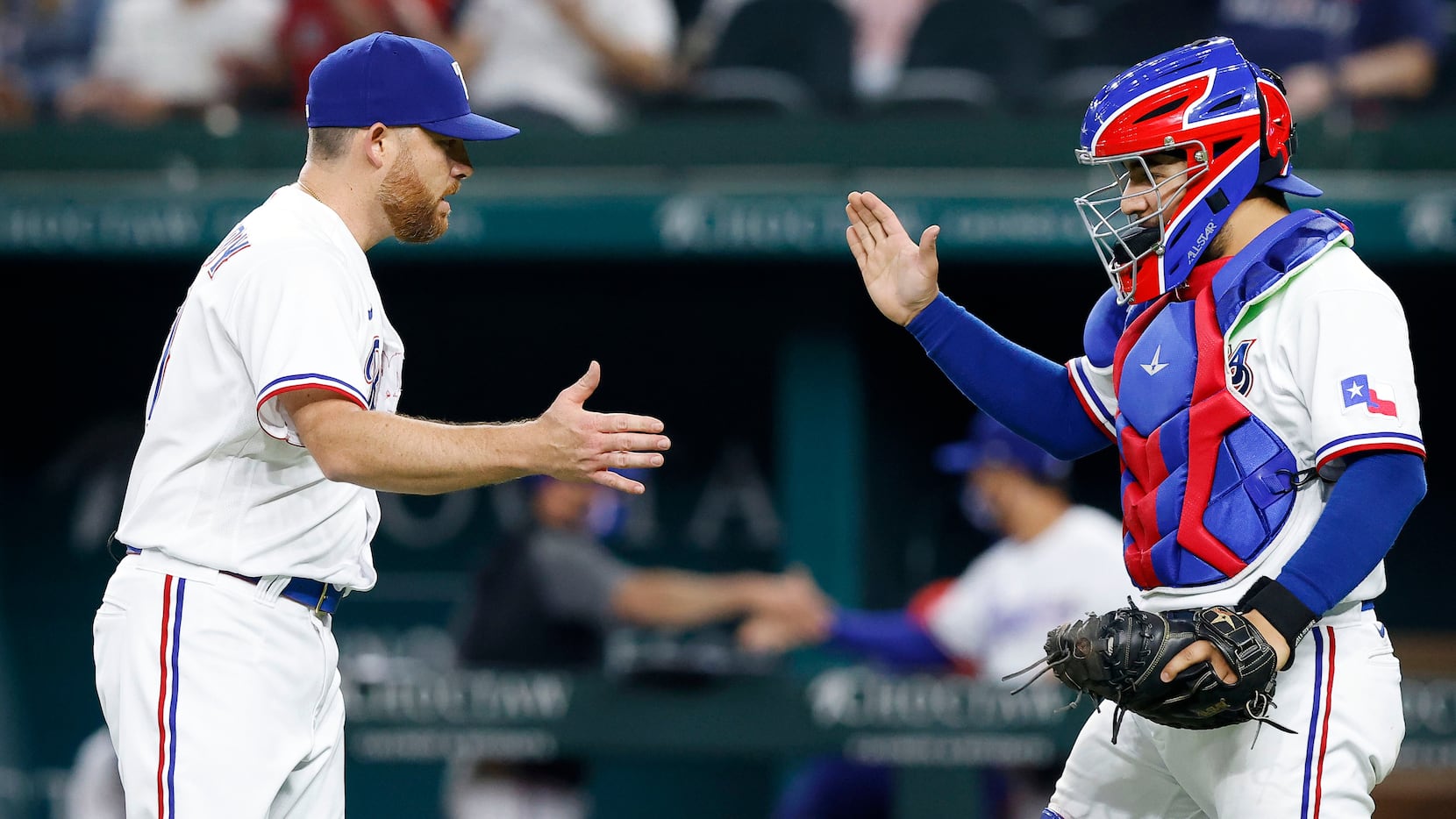 Texas Rangers relief pitcher Ian Kennedy (31) is congratulated by catcher Jose Trevino (23)...