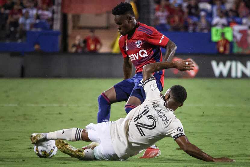 Los Angeles FC defender Diego Palacios (12) slides to kick the ball from possession of FC...