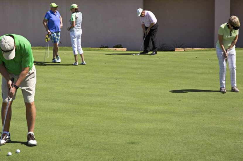 Patrons use a putting green at The Clubs of Prestonwood in Dallas.  (File Photo/The Dallas...
