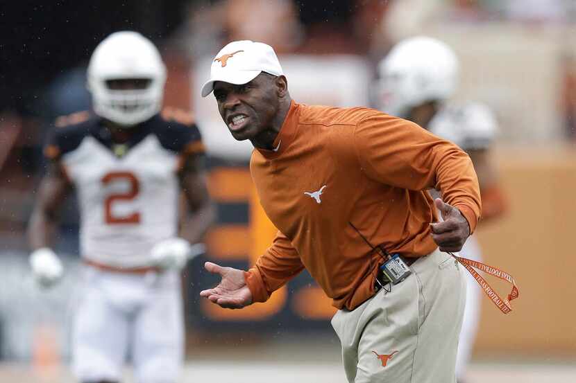 Texas head coach Charlie Strong talks to his players during a spring NCAA college football...