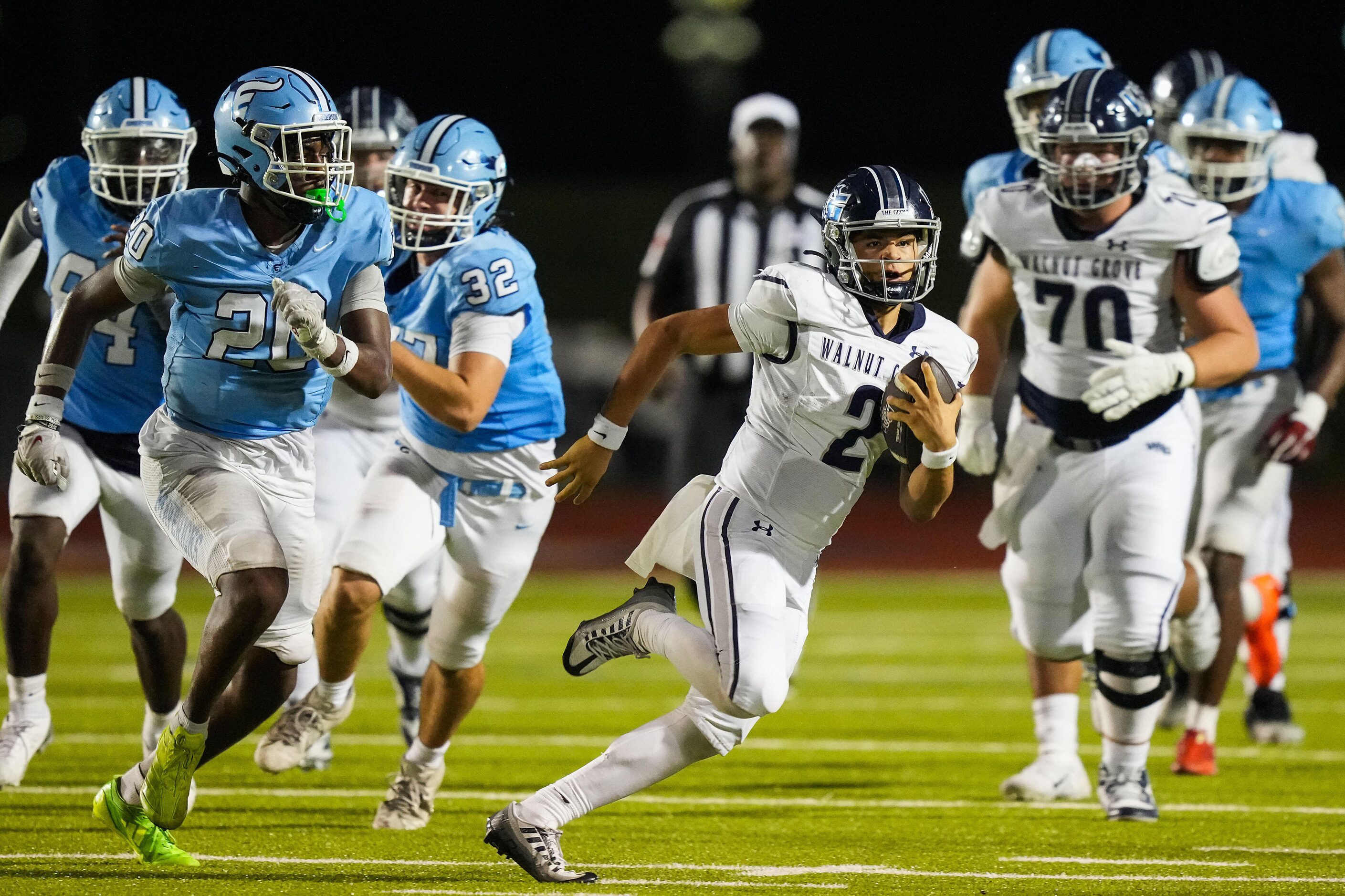 Prosper Walnut Grove quarterback Hayes Hackney (2) races past Frisco Emerson linebacker...