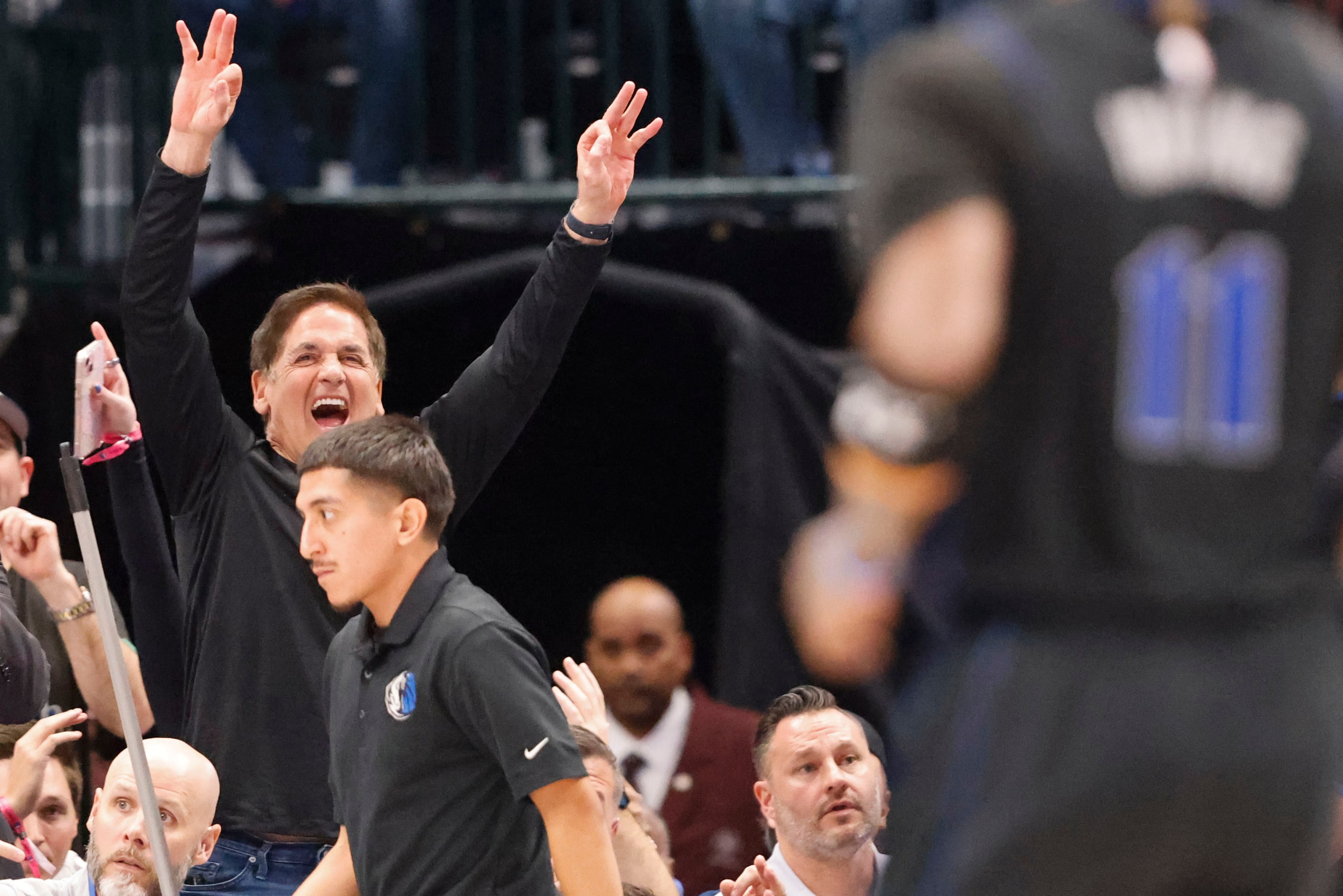 Dallas Mavericks alternate Governor Mark Cuban reacts towards a three-pointer scored by...