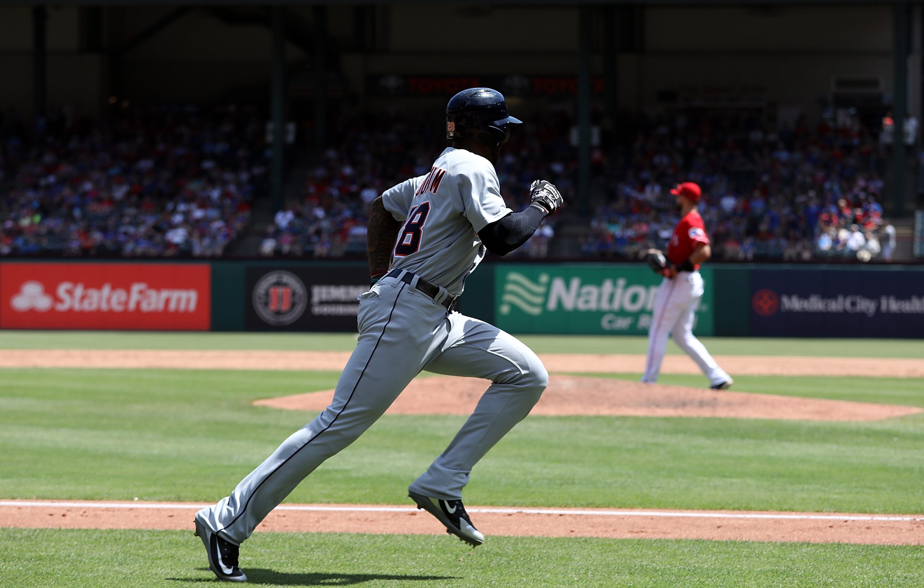 ARLINGTON, TX - MAY 09:  Niko Goodrum #28 of the Detroit Tigers scores a run in the sixth...