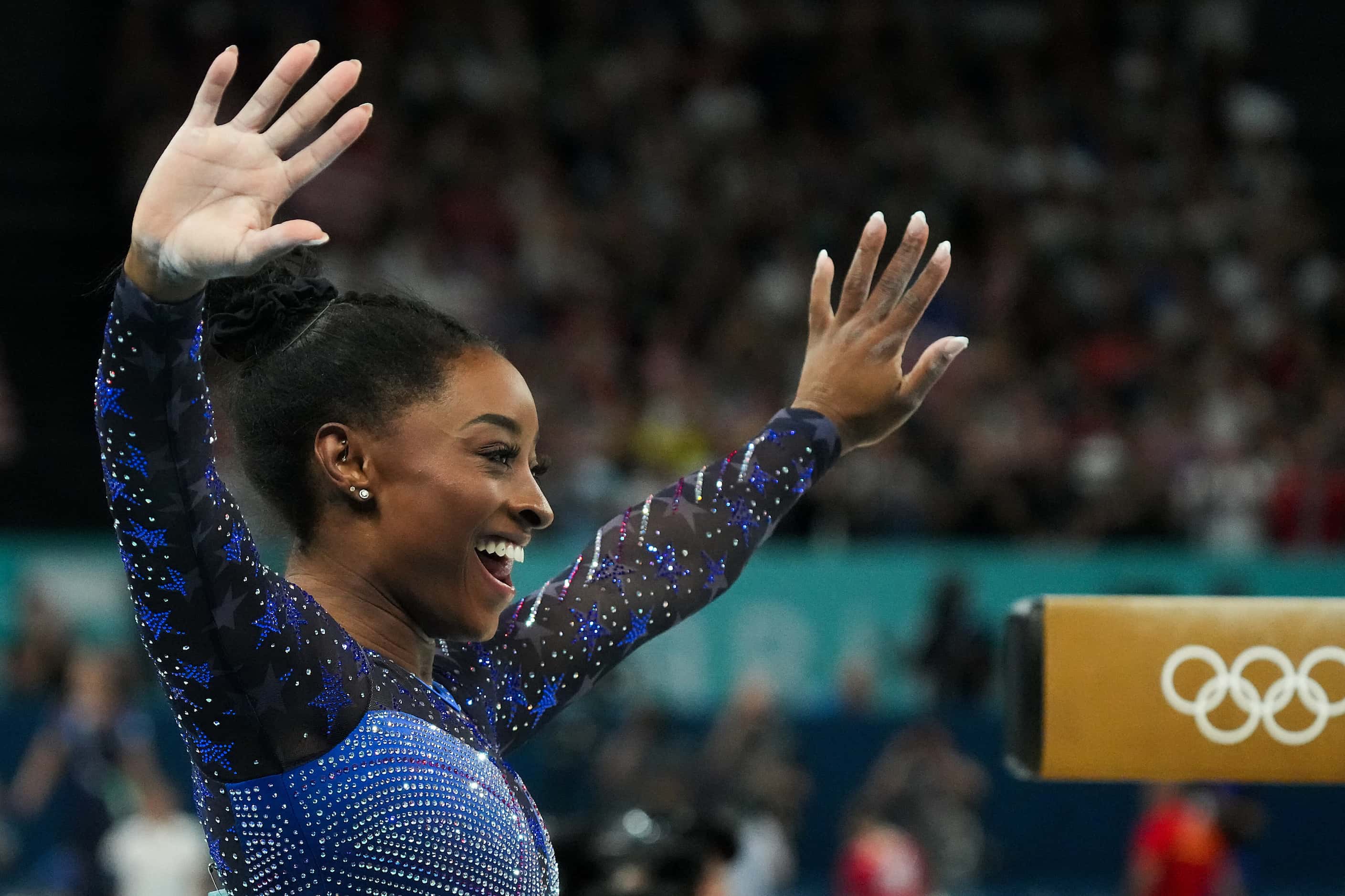 Simone Biles of the United States celebrates after competing on the balance beam during the...