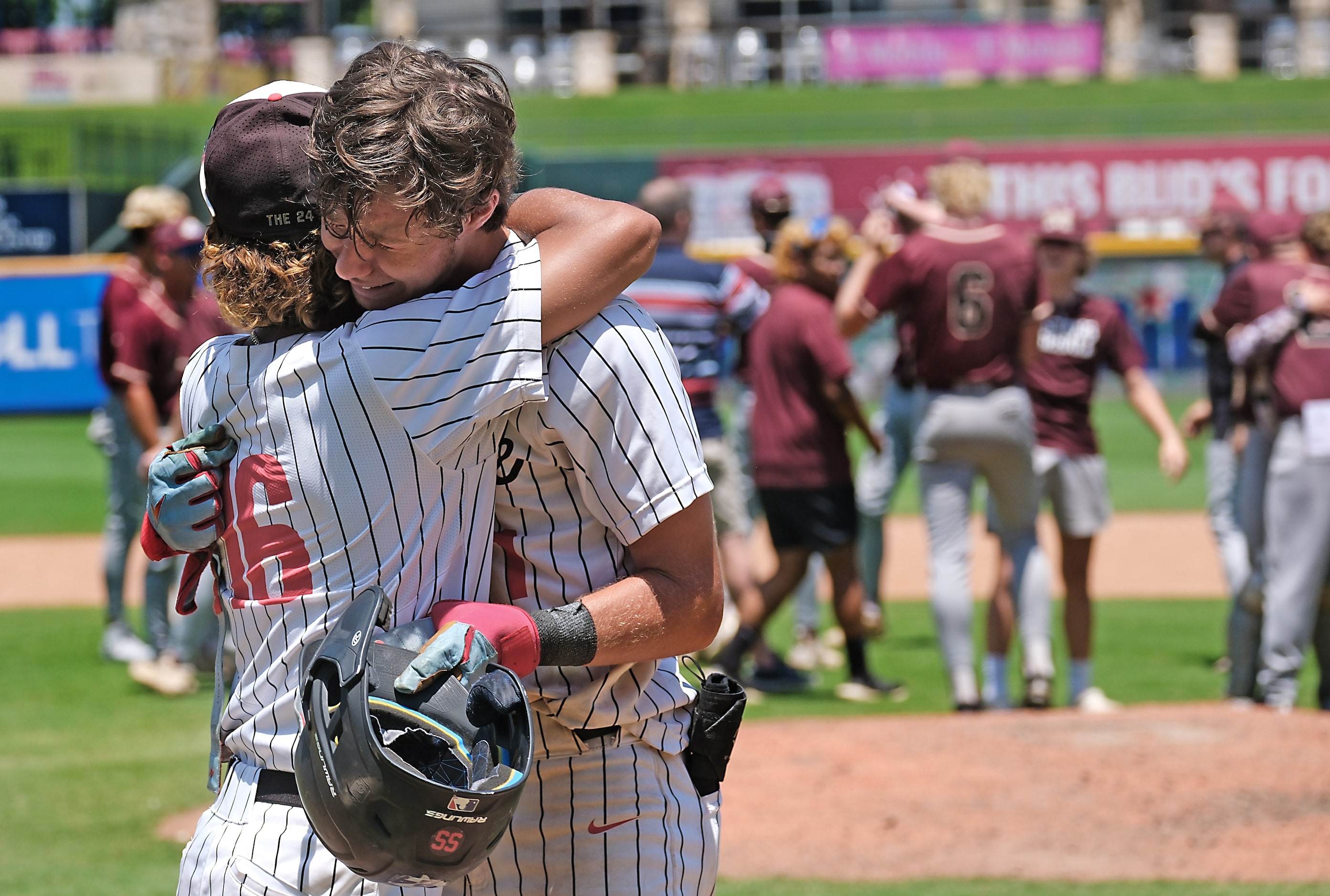 Argyle Grady Emerson, (1), is comforted by Jaxon Greene, (16), after Emerson’s line drive...