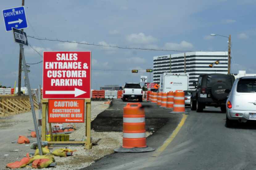 Businesses try to direct customers near construction on LBJ Freeway and Welch Road on...