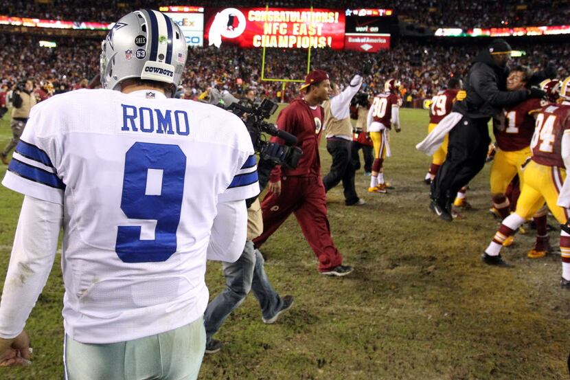 Dallas Cowboys quarterback Tony Romo (9) walks off the field as the Redskins celebrate...