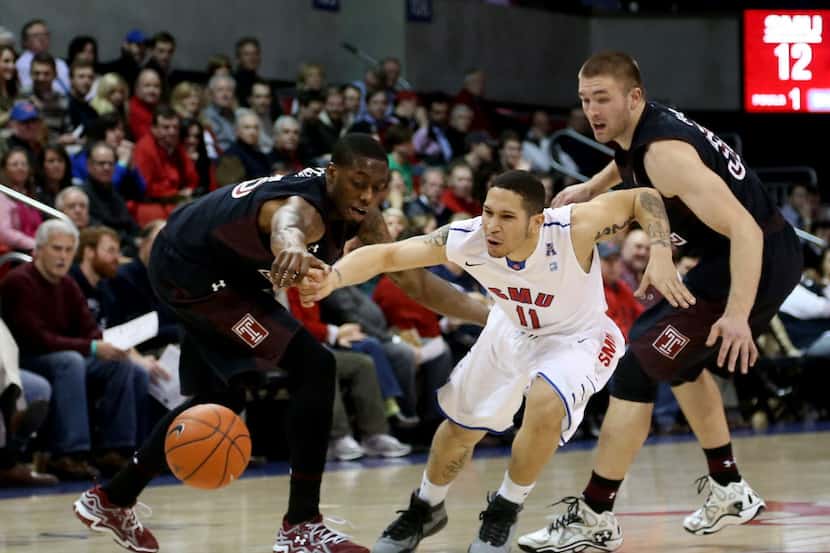 SMU Mustangs guard Nic Moore (11) is fouled by Temple Owls guard Quenton DeCosey (25) in the...
