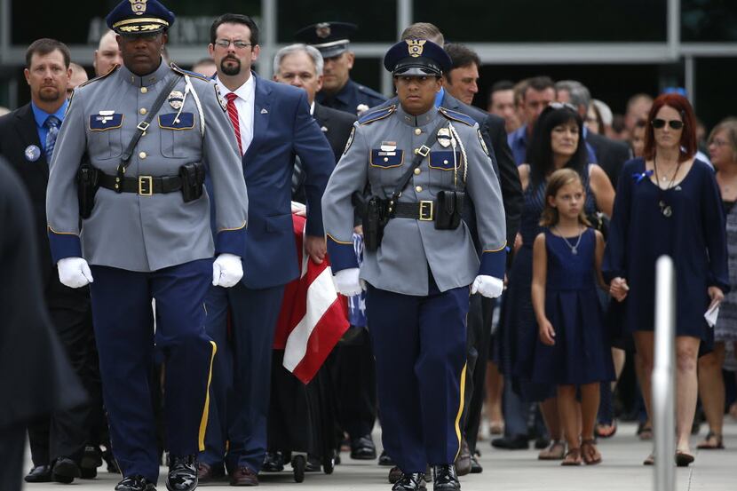 Pallbearers escorted the flag-draped casket of slain Baton Rouge police officer Matthew...