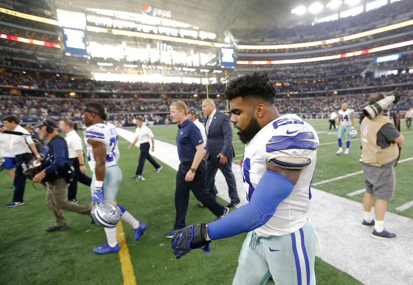 Dallas Cowboys running back Ezekiel Elliott (21) walks off the field after losing to the...