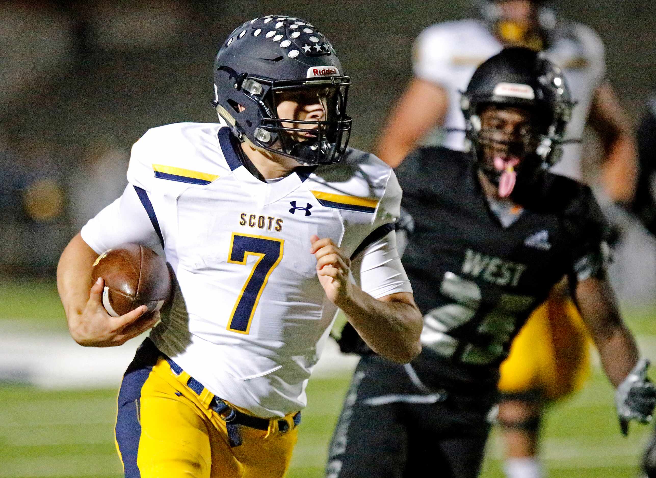 Highland Park High School quarterback Brennan Storer (7) runs for his second touchdown...