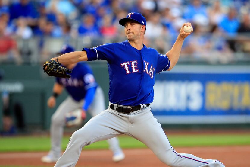 Texas Rangers starting pitcher Mike Minor delivers to a Kansas City Royals batter during the...