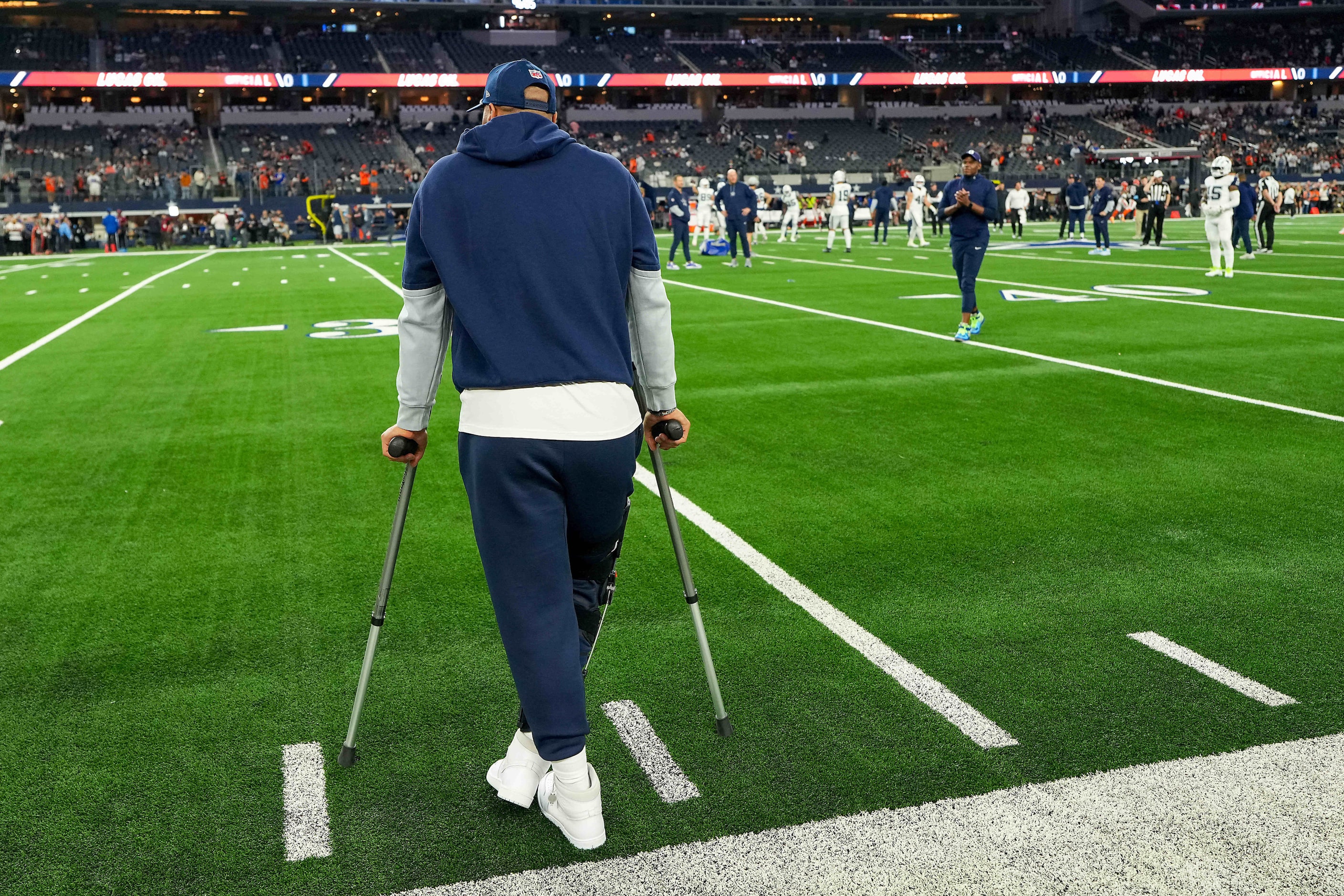 Dallas Cowboys quarterback Dak Prescott watches the teams warm up before an NFL football...