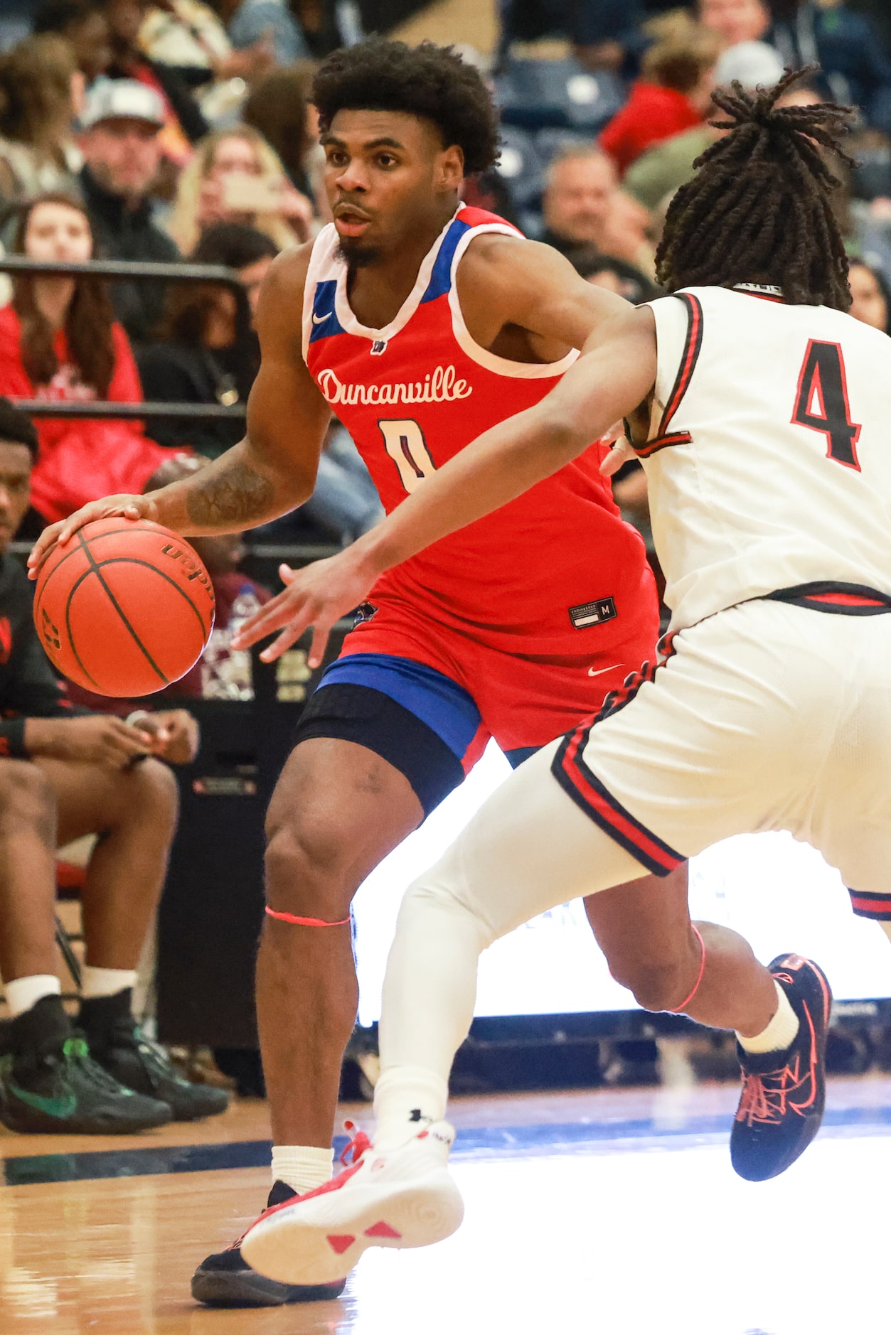 Duncanville High School’s K.J. Lewis (0) dribbles around Mansfield Legacy High School’s Amir...