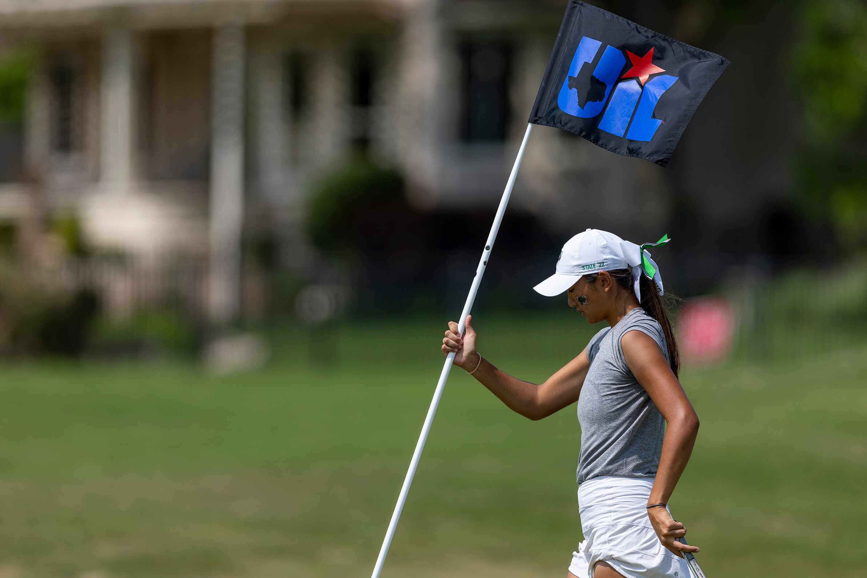 Southlake Carroll’s Ashley Kim hits replaces the pin on the 10th green during the 6A girls...