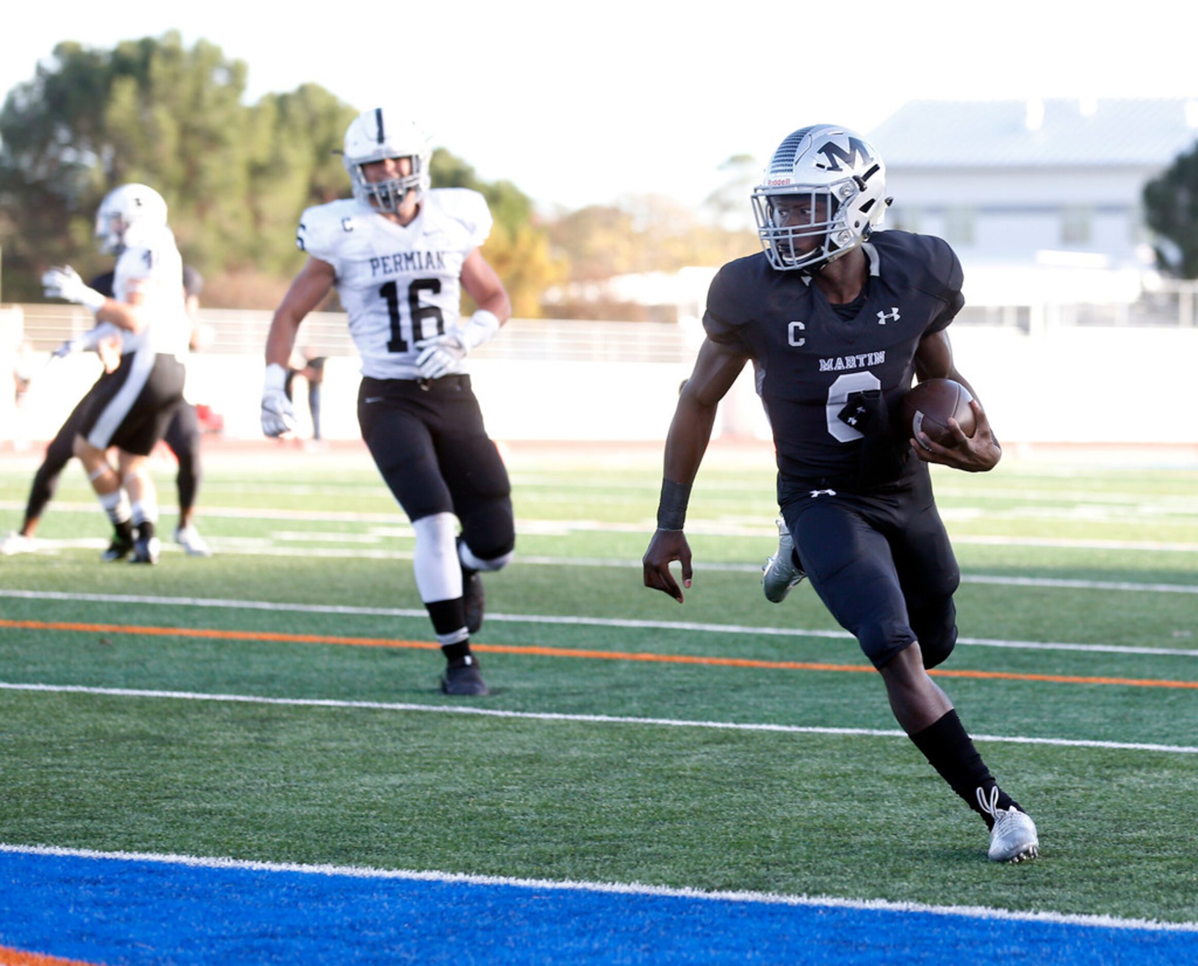 Arlington Martin quarterback Juma Otoviano  (8) scores on a keeper in front of Odessa...