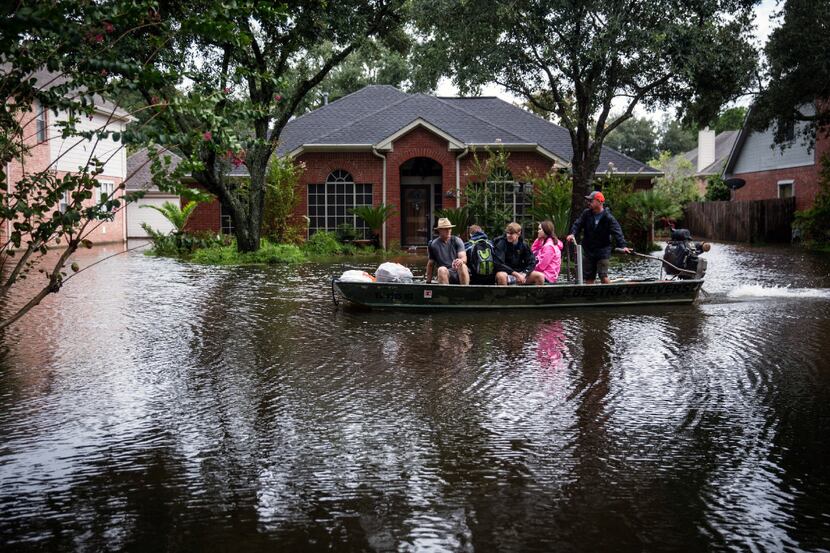 A volunteer search and rescue team evacuates Rodney Graham, left, from a Houston...