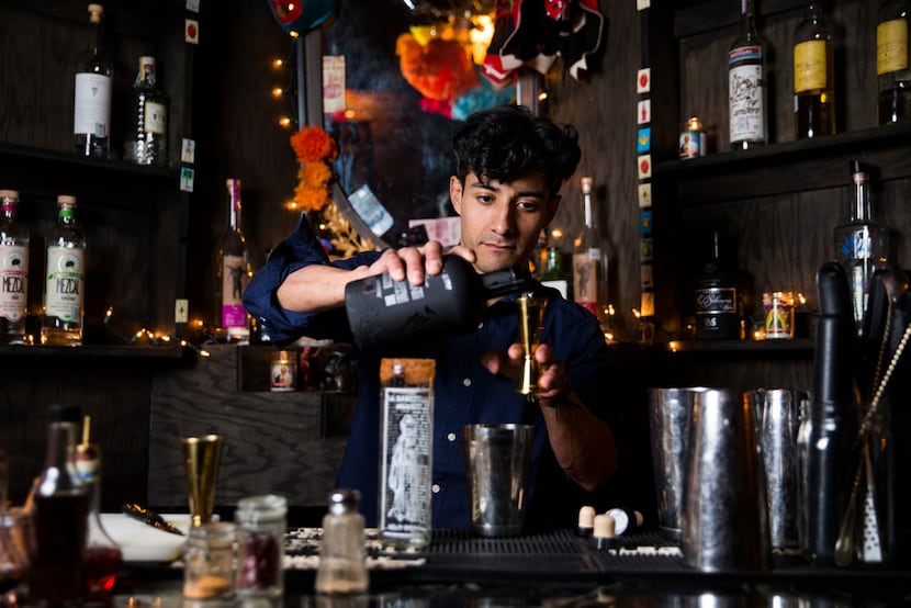 Bartender Daniel Zapata mixes a Palani drink, which contains tepache, at Santos y Pecadores...