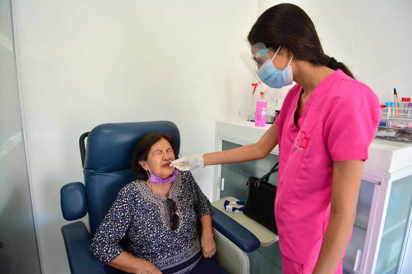 Lab technician Fátima Torres gives a COVID-19 test to Ramona Guadalupe Mejía Escalante at a...
