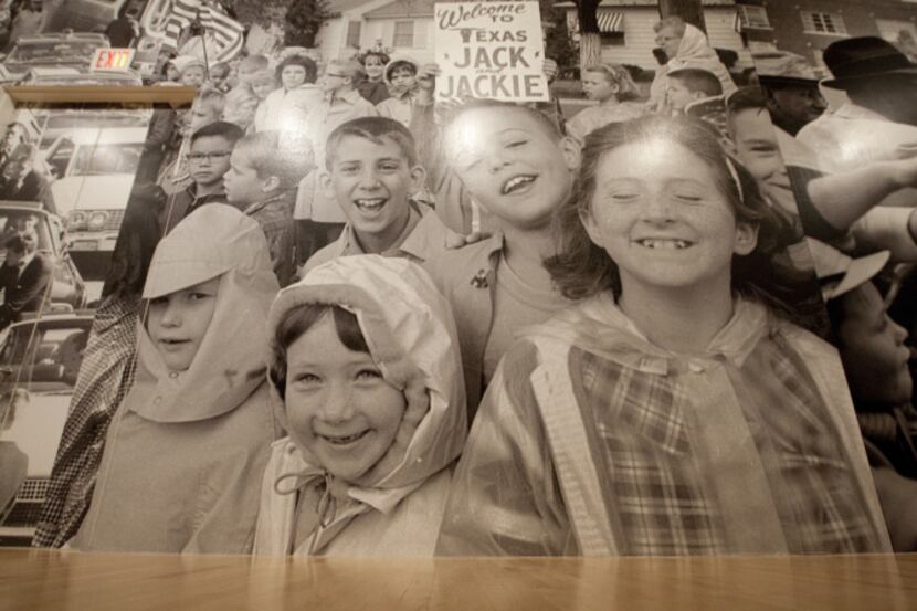 AN enlarged photograph of children welcoming the president to Texas covers an entire wall of...