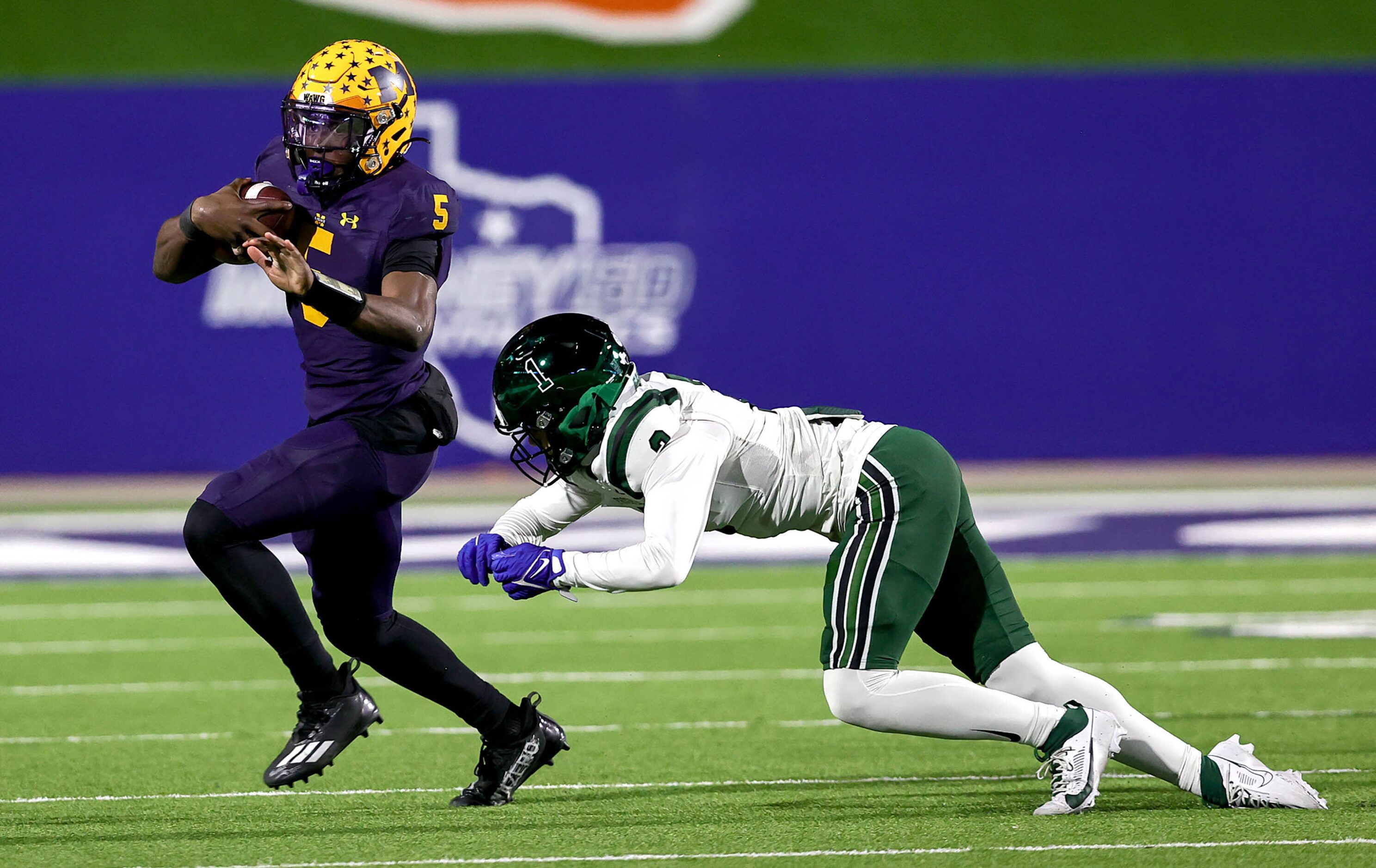 McKinney quarterback Godspower Nwawuihe (5) looks to avoid gets stopped by Prosper...