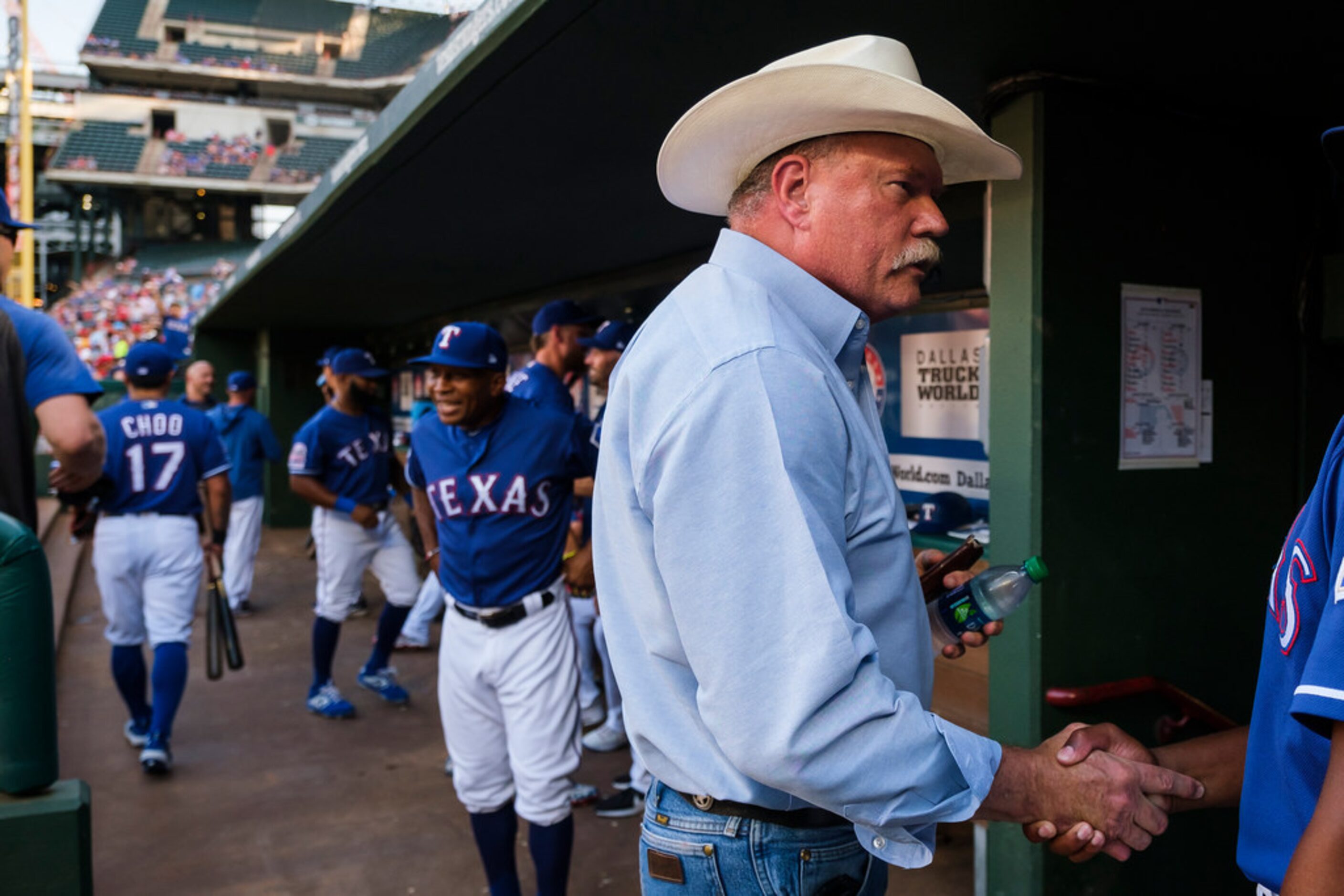 Tarrant Sheriff Bill E. Waybourn greets players in the Texas Rangers dugout before a game...