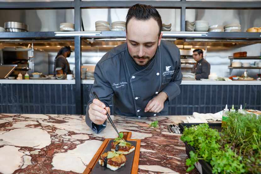 Executive chef Jonah Friedmann places the finishing touches on dishes at Margaret’s, a new...