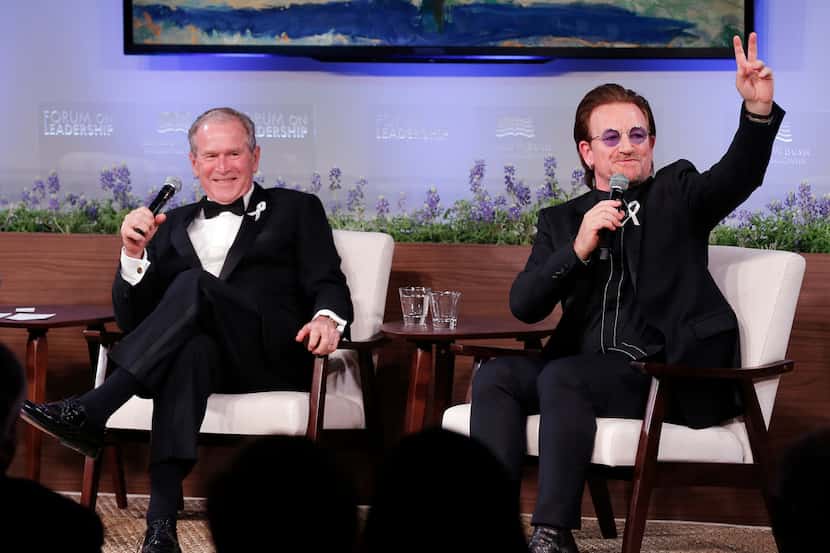 Former President George W. Bush, left, and U2 musician Bono participate in a Q&A session...