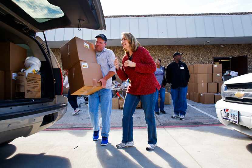 Volunteers pack cars full of boxes of food at the Frisco Family Services Thanksgiving dinner...