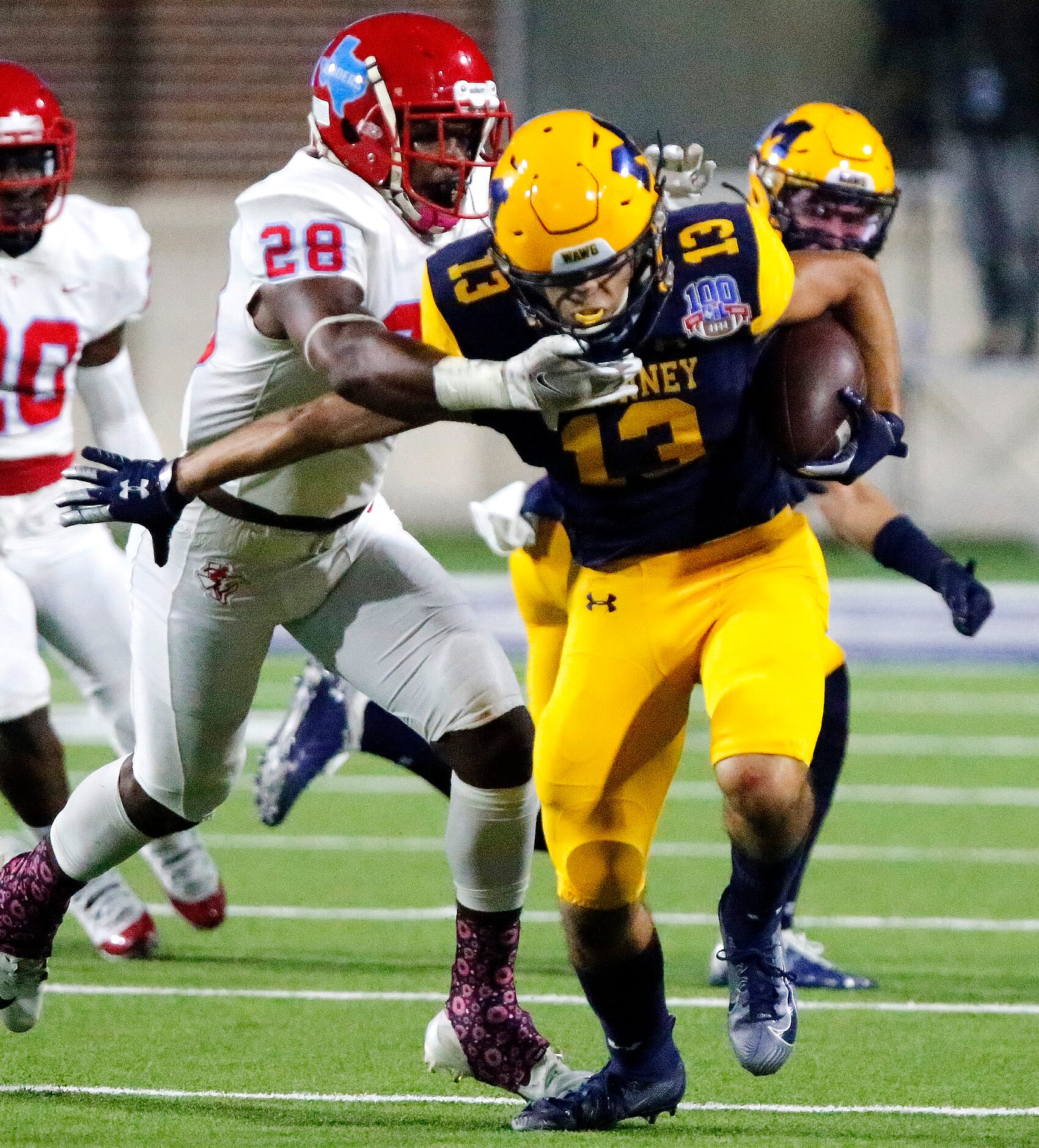 McKinney High School wide receiver Cameron Rivas (13) is caught after the catch by Skyline...