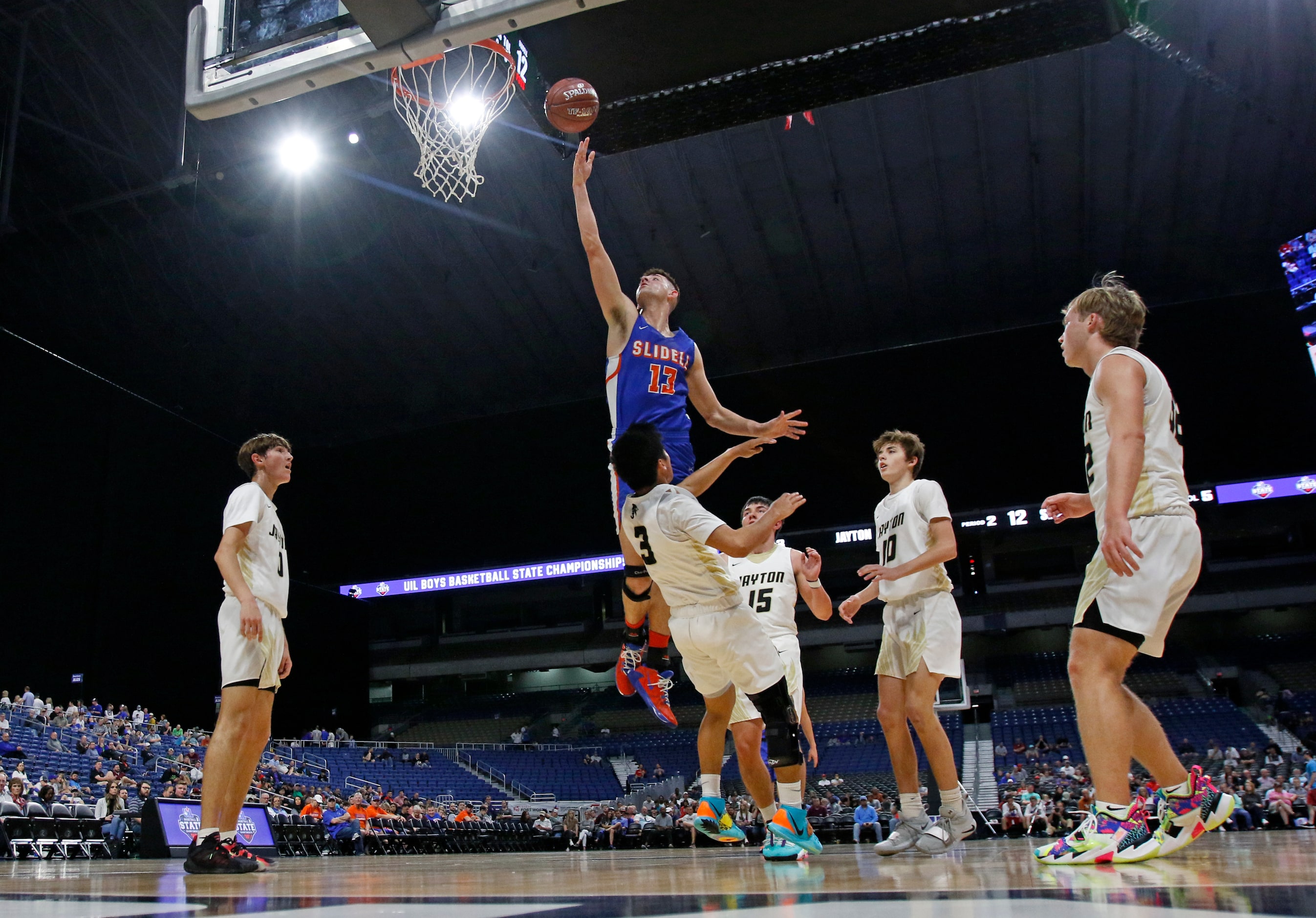 Slidell center Slayton Pruett #13 drives for two over Jayton guard Aaron Hernandez #3....