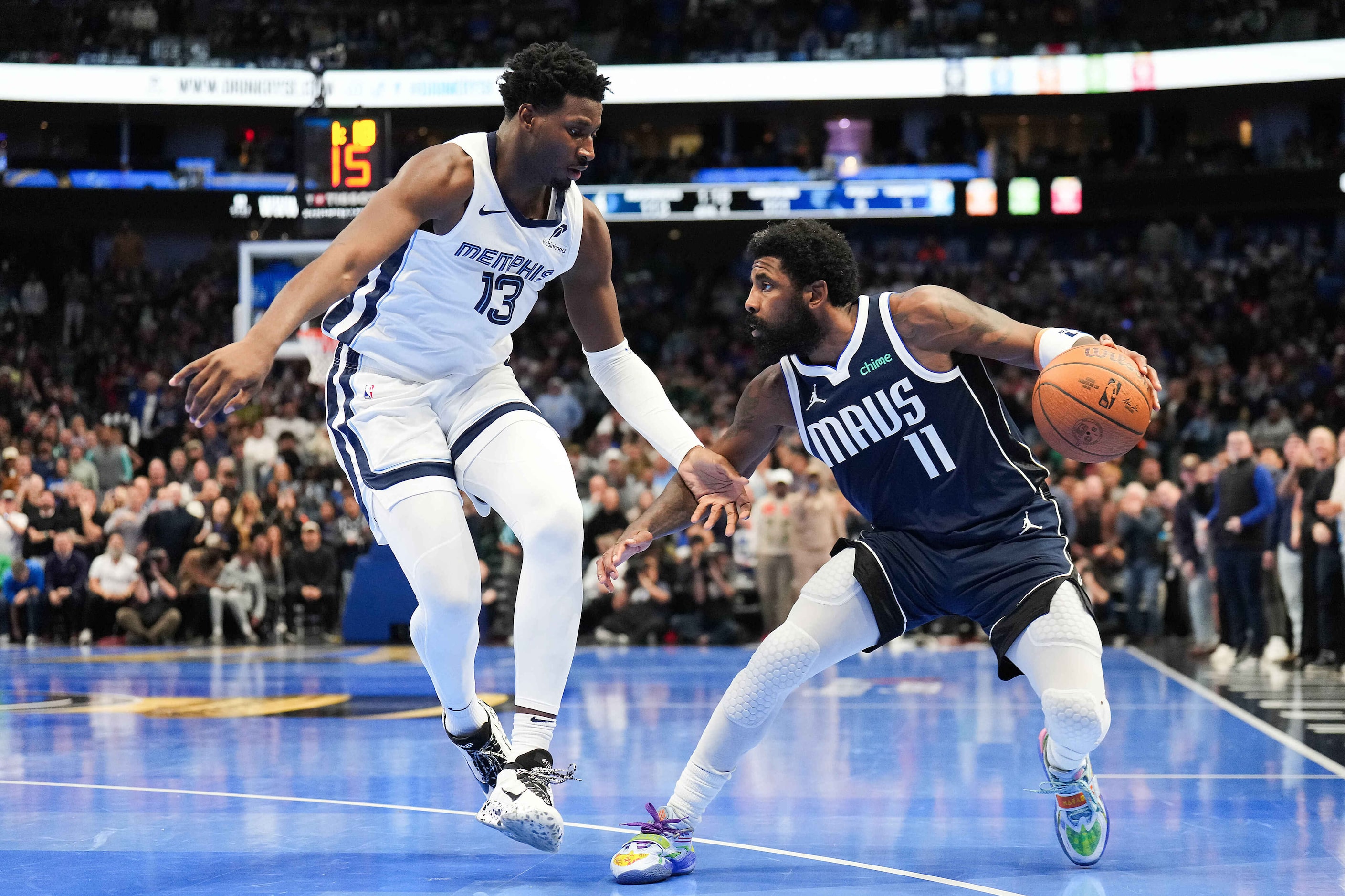 Dallas Mavericks guard Kyrie Irving (11) drives on Memphis Grizzlies forward Jaren Jackson...