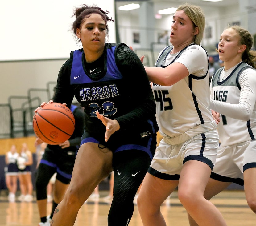 Hebron forward Jordan Thomas (22) tries to dribble to the basket against Flower Mound on...