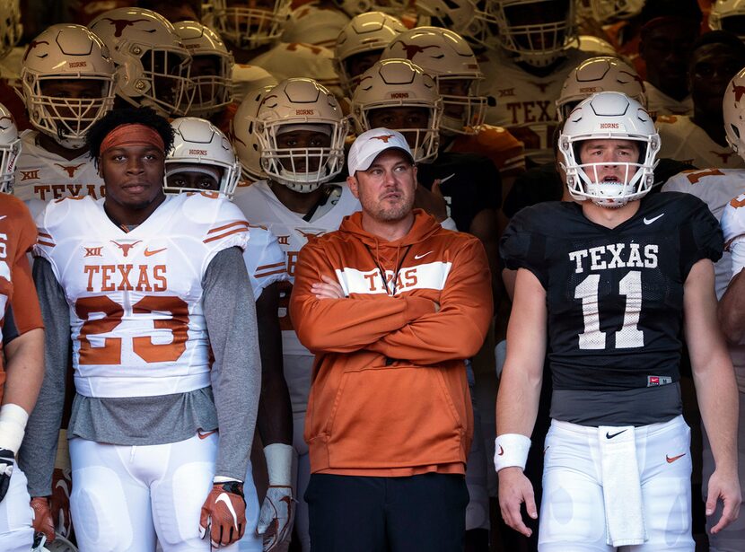 University of Texas linebacker Jeffrey McCulloch (23) and quarterback Sam Ehlinger (11)...