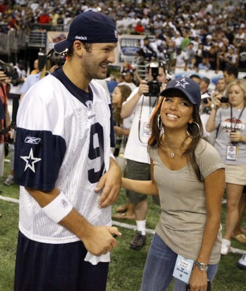 Tony Romo chats with Eva Longoria after morning practice at the Cowboys training camp at the...