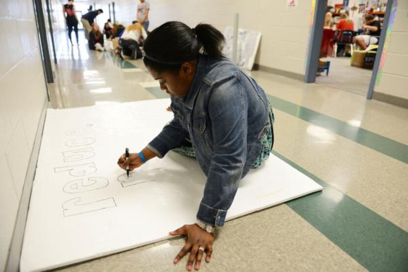
Sydney Franklin, Student Council president, works on a poster during Suzanne Reese's...