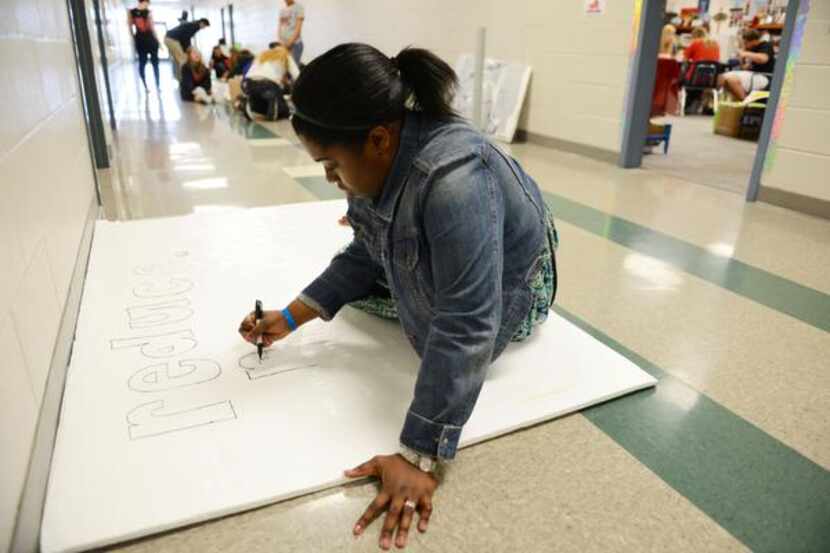 
Sydney Franklin, Student Council president, works on a poster during Suzanne Reese's...