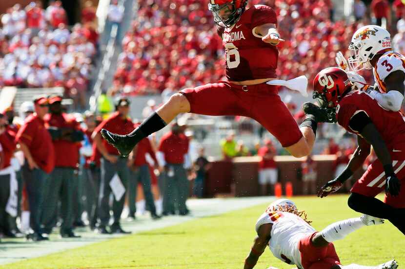 FILE - In this Oct. 7, 2017, file photo, Oklahoma quarterback Baker Mayfield (6) leaps over...