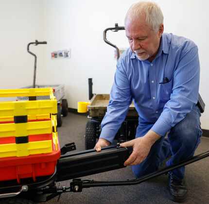 Inventor and business owner Ed MacDonald shows a battery that he pulls it out from his...
