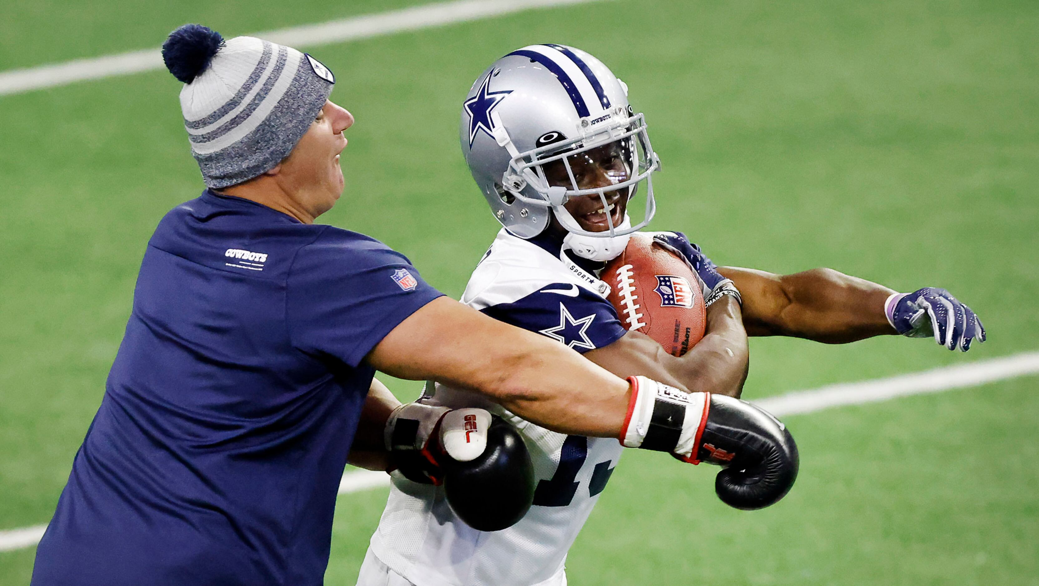 Dallas Cowboys wide receiver Michael Gallup (13)  runs through a tackling drill during a...