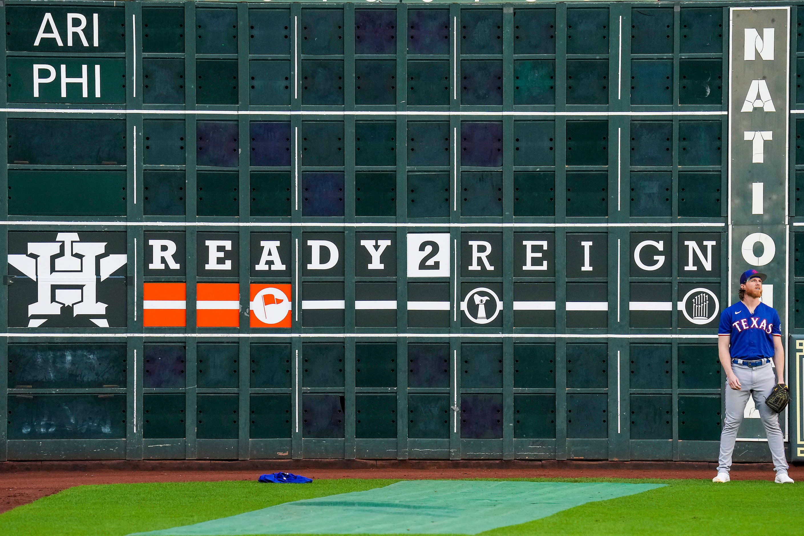 Texas Rangers pitcher Jon Gray stretches in the outfield during a workout in preparation for...