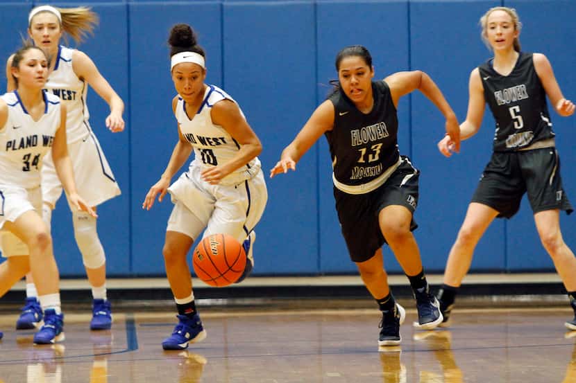 Plano West freshman guard Jaden Owens (10) fights for control of the ball against Flower...