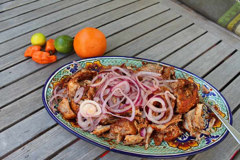 A platter of cochinita pibil, Yucatan slow-cooked pork, fresh from the slow cooker. The...