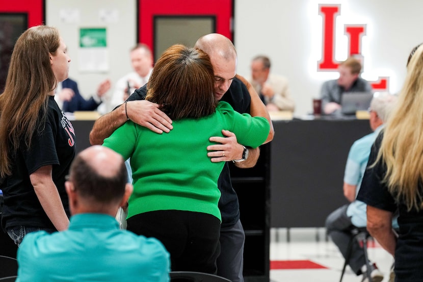 Parent Lane Wakefield hugs State Board of Education member Evelyn Brooks after she spoke...