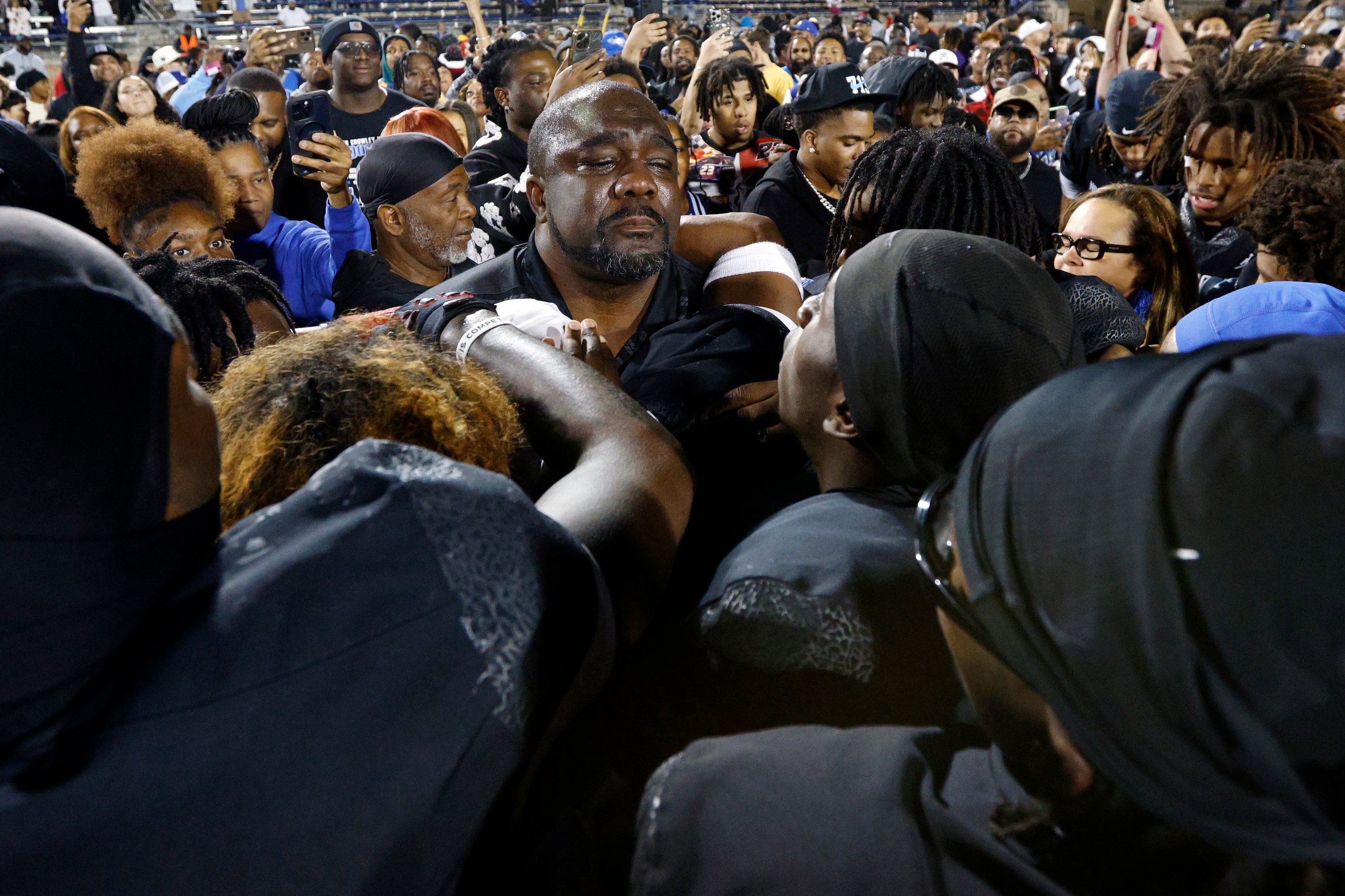 North Crowley players comfort head coach Ray Gates as he’s overcome with emotion after...