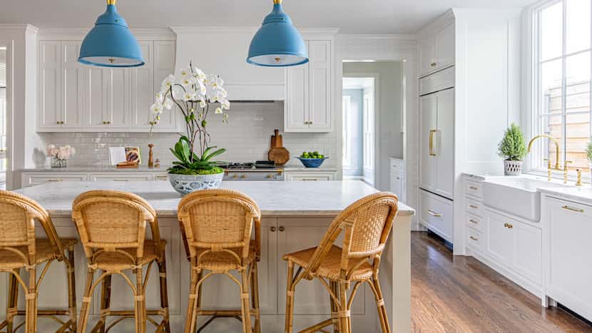 The kitchen features white cabinets, a gray stove, and gold hardware.