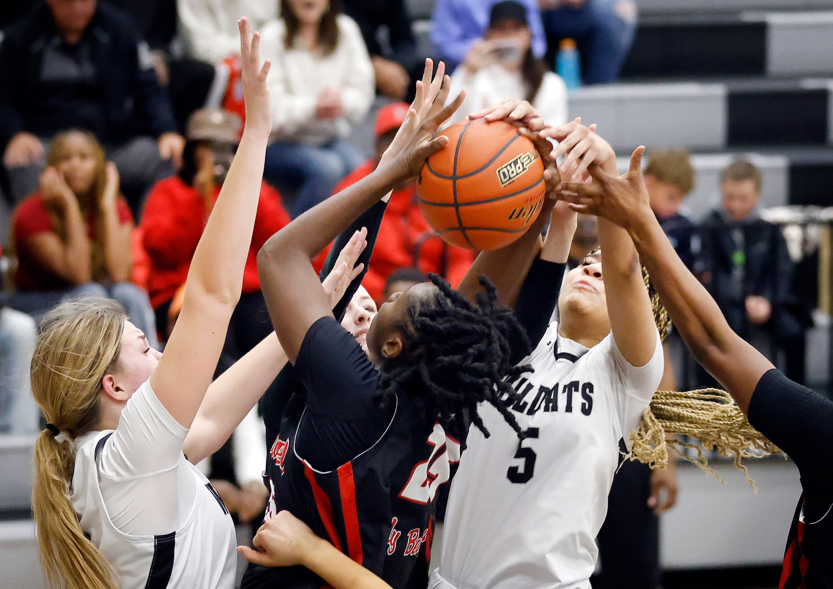 Denton Braswell center Amaya McDonald (25) comes down with a rebound as she’s covered by...