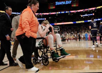Baylor forward Lauren Cox (15) is assisted off the court after she injured her knee on a...